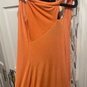 Full length orange dress, one strap and sleeveless.